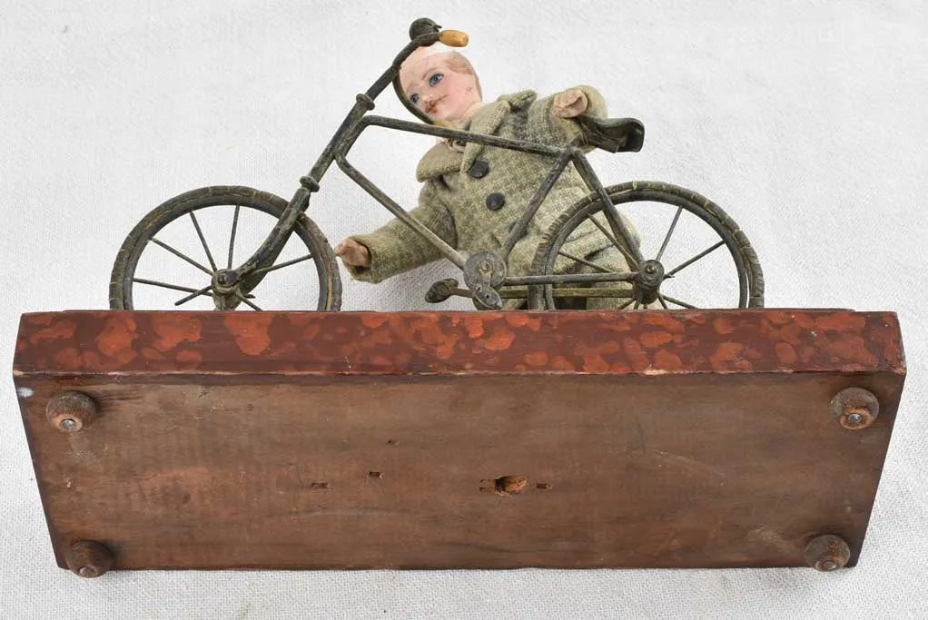 1910's artistic sculpture of an old fellow repairing his bicycle 8¼"