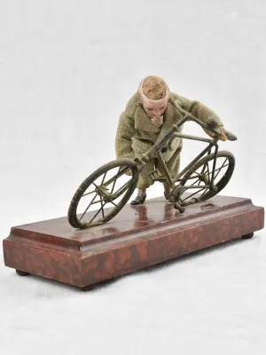 1910's artistic sculpture of an old fellow repairing his bicycle 8¼"