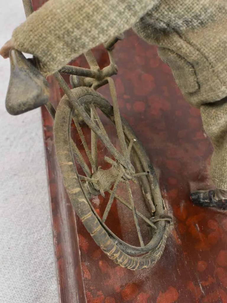 1910's artistic sculpture of an old fellow repairing his bicycle 8¼"