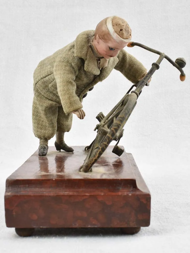 1910's artistic sculpture of an old fellow repairing his bicycle 8¼"