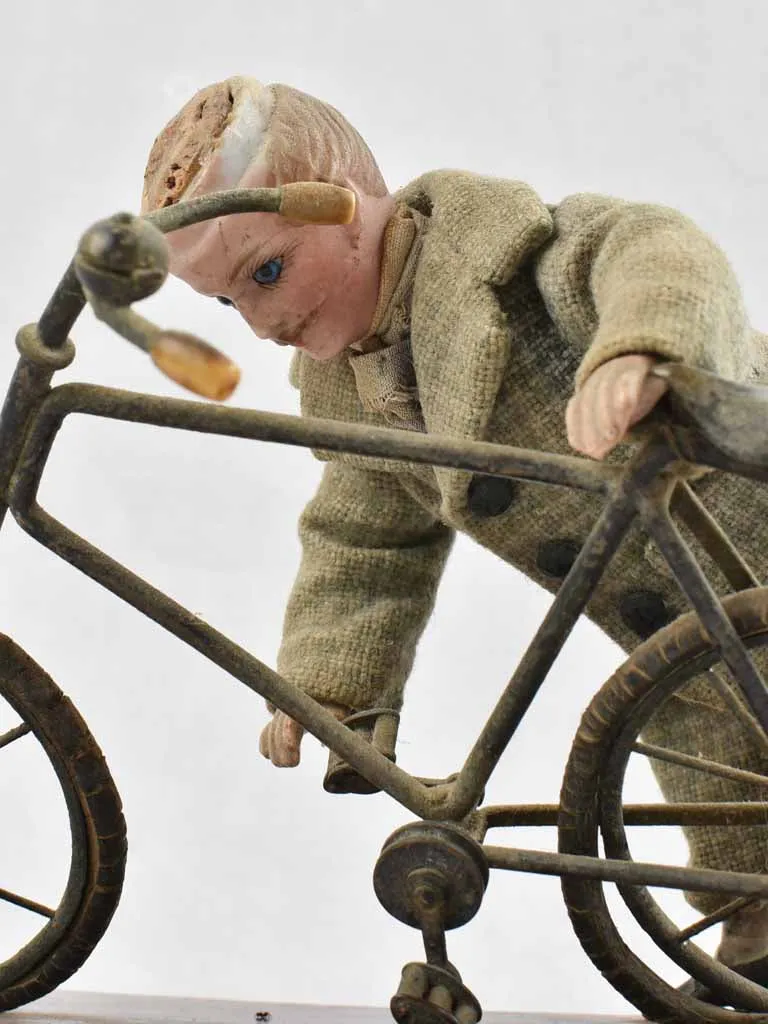 1910's artistic sculpture of an old fellow repairing his bicycle 8¼"
