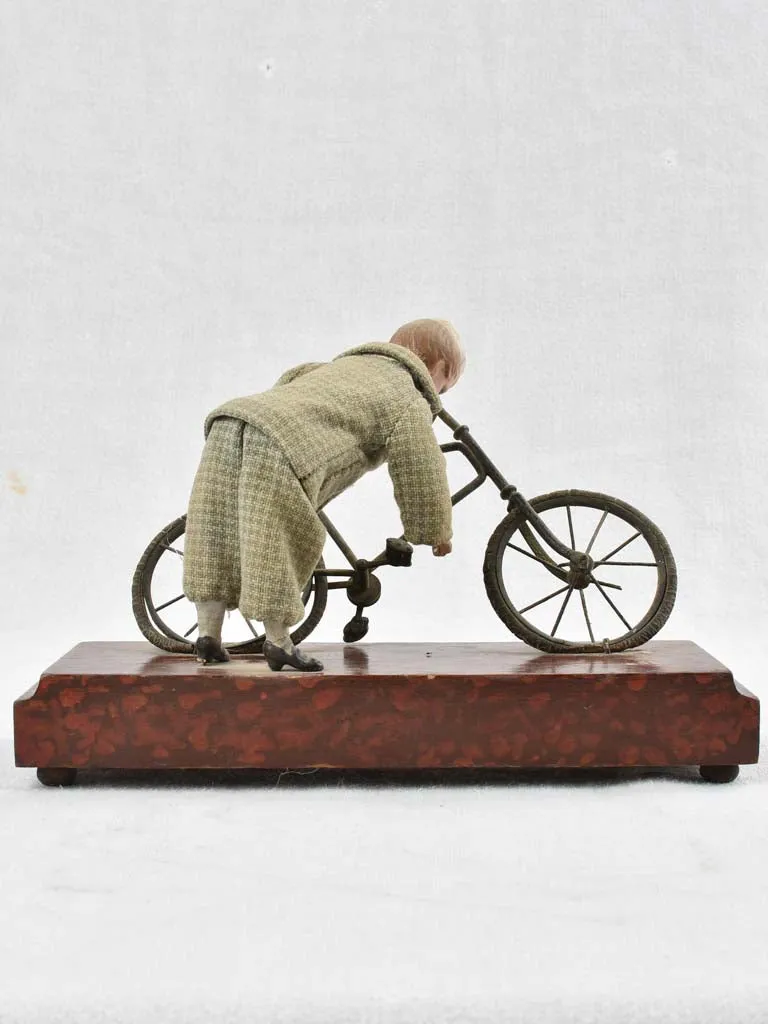 1910's artistic sculpture of an old fellow repairing his bicycle 8¼"